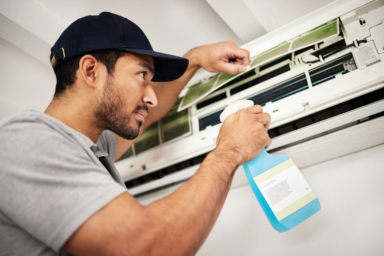 air conditioner cleaning and man with electrical machine check in a home with ac