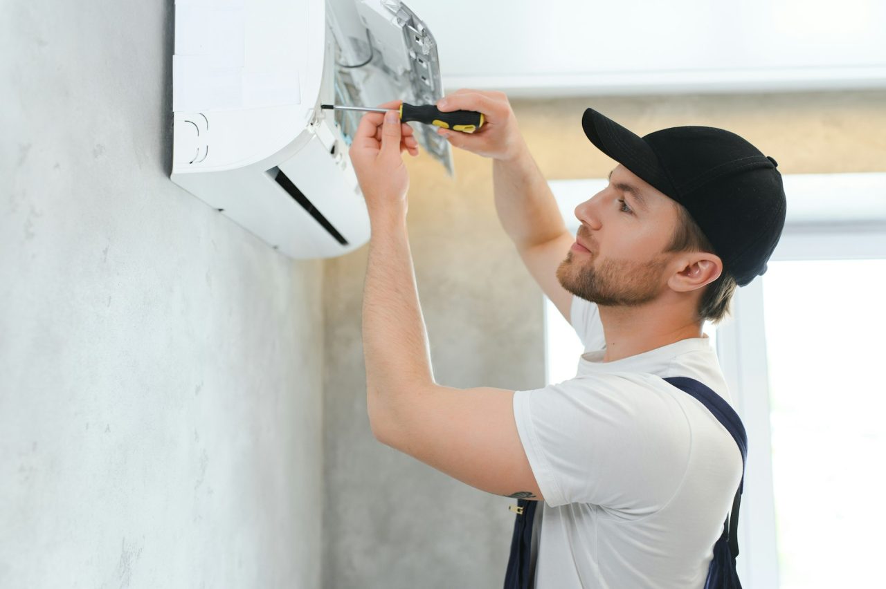 service man is cleaning repair and maintenance of air conditioner 1 3